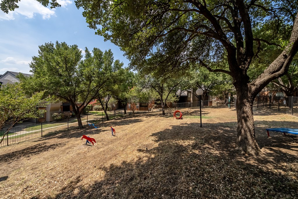 Dog park with fence at Trinity Apartments, Texas