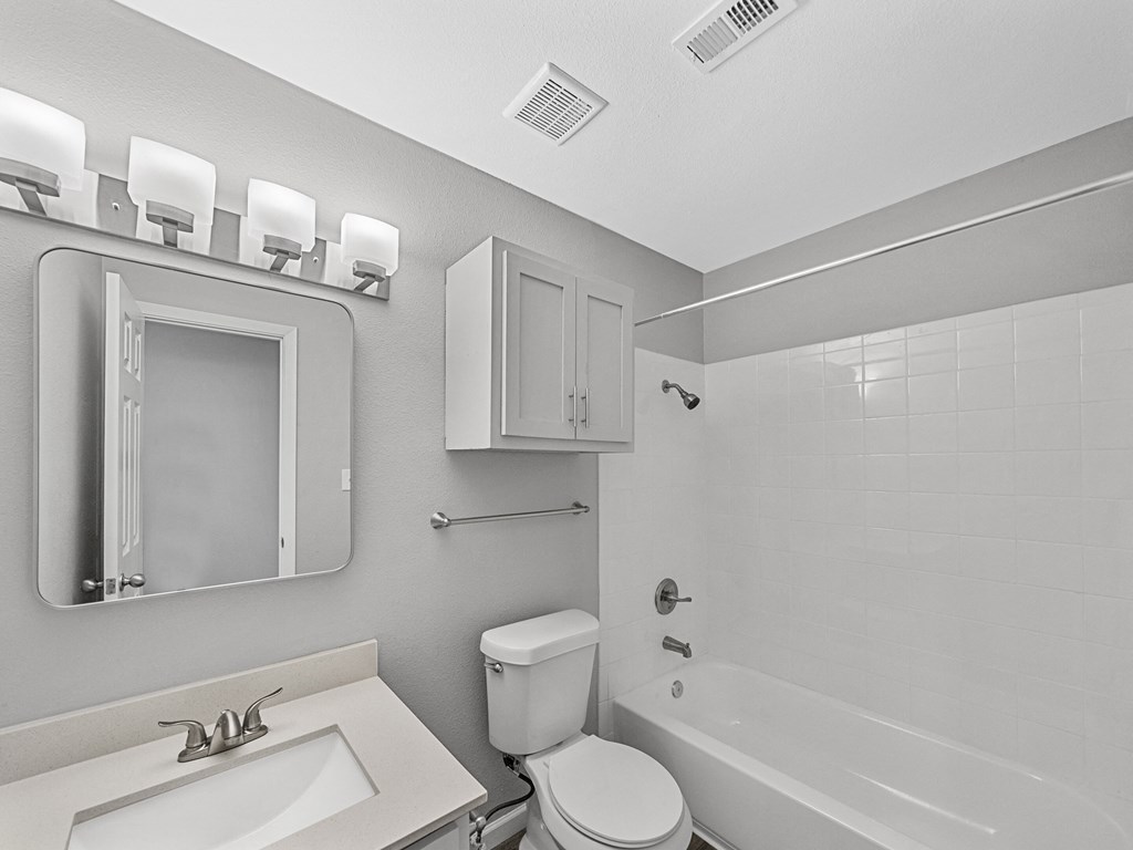a bathroom with a sink toilet and a bath tub