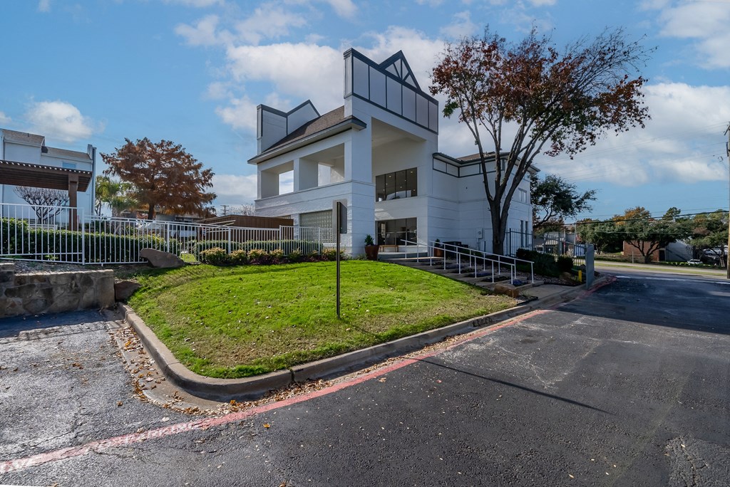 a large white house with a yard in front of it