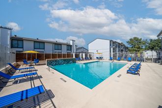 our apartments have a large pool and lounge chairs at our apartments