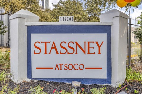 a sign in front of a fence