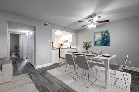 A dining room with a table set for four.