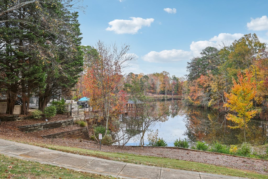 A lake surrounded by trees with autumn leaves.