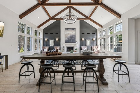 A large dining room with a wooden table and chairs.