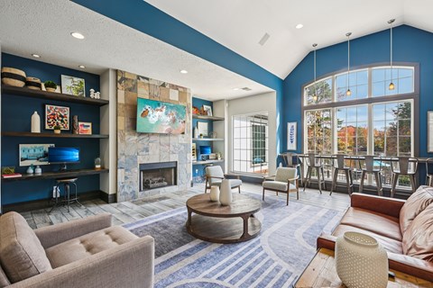 A living room with a fireplace and a painting on the wall.