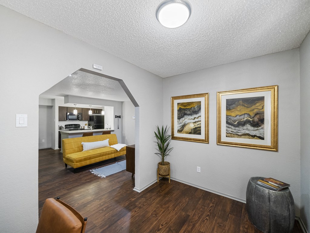 Living room with yellow couch at Trinity Apartments, Irving, Texas