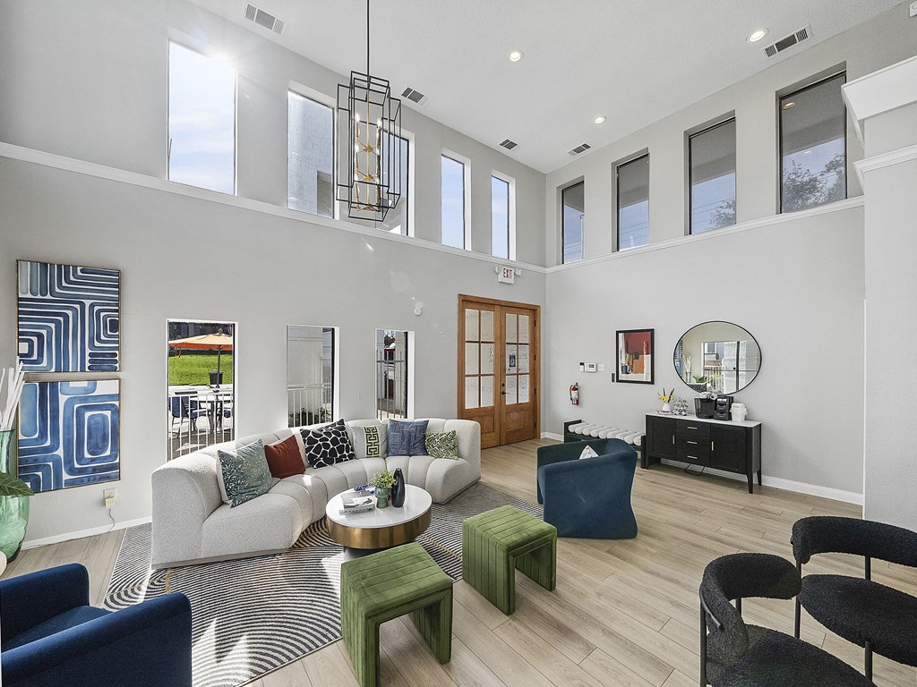 a living room with a couch and chairs and a table