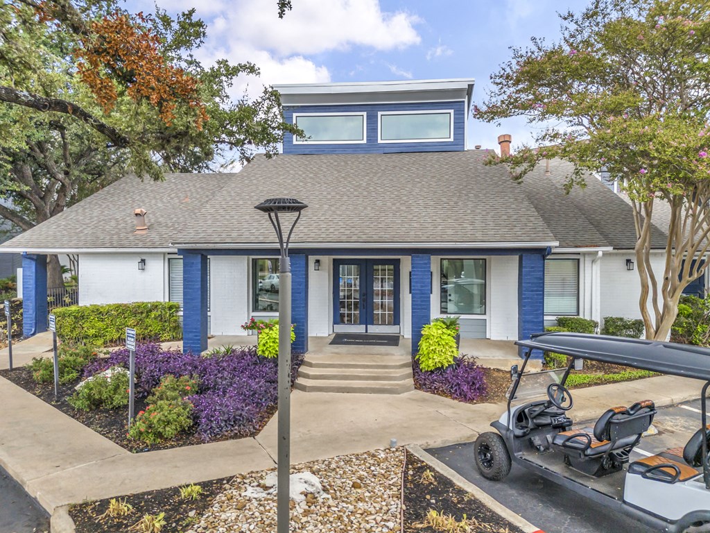 a blue house with a golf cart parked in front of it