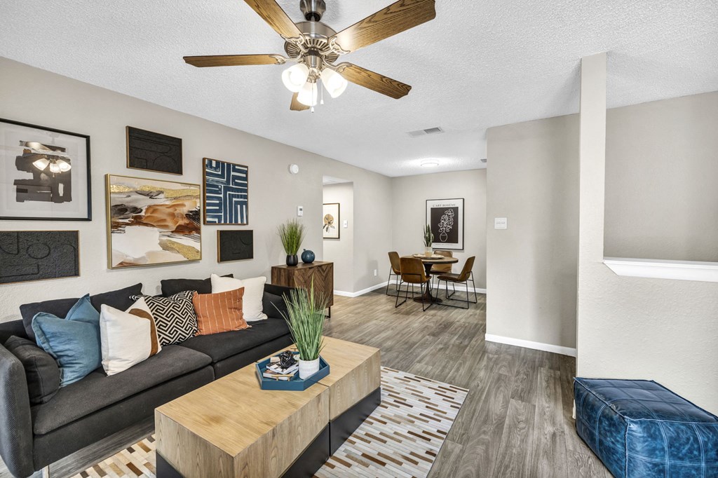 a living room with a couch and a ceiling fan