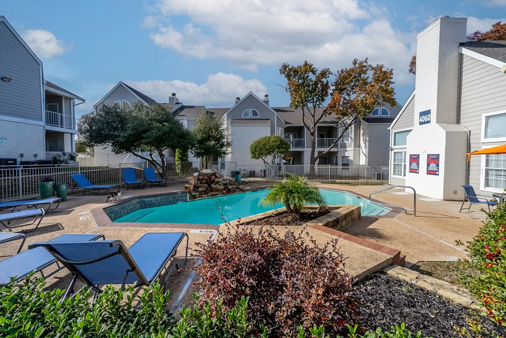 our apartments have a swimming pool and a patio with chairs