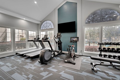 A spacious home gym with a variety of exercise equipment.