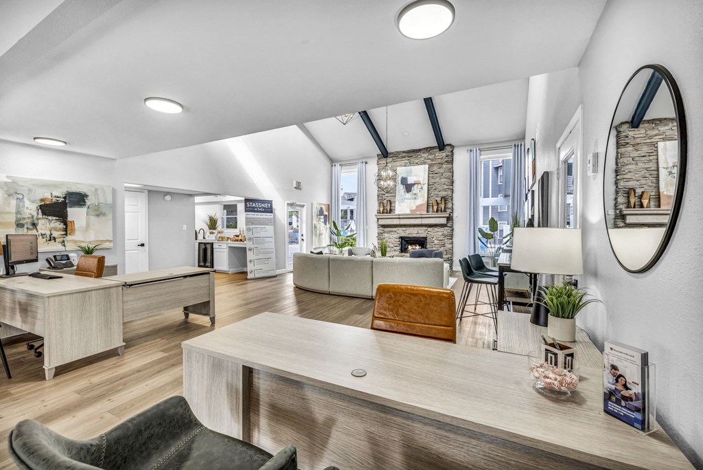 a living room with a table and a mirror