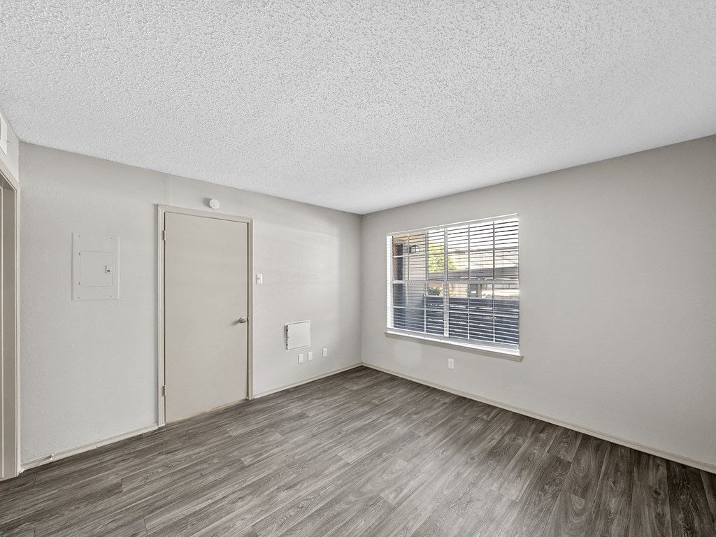 Bedroom with hardwood floors at Trinity Apartments, Texas