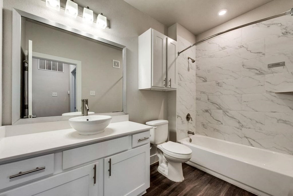 a bathroom with a sink and a toilet and a shower