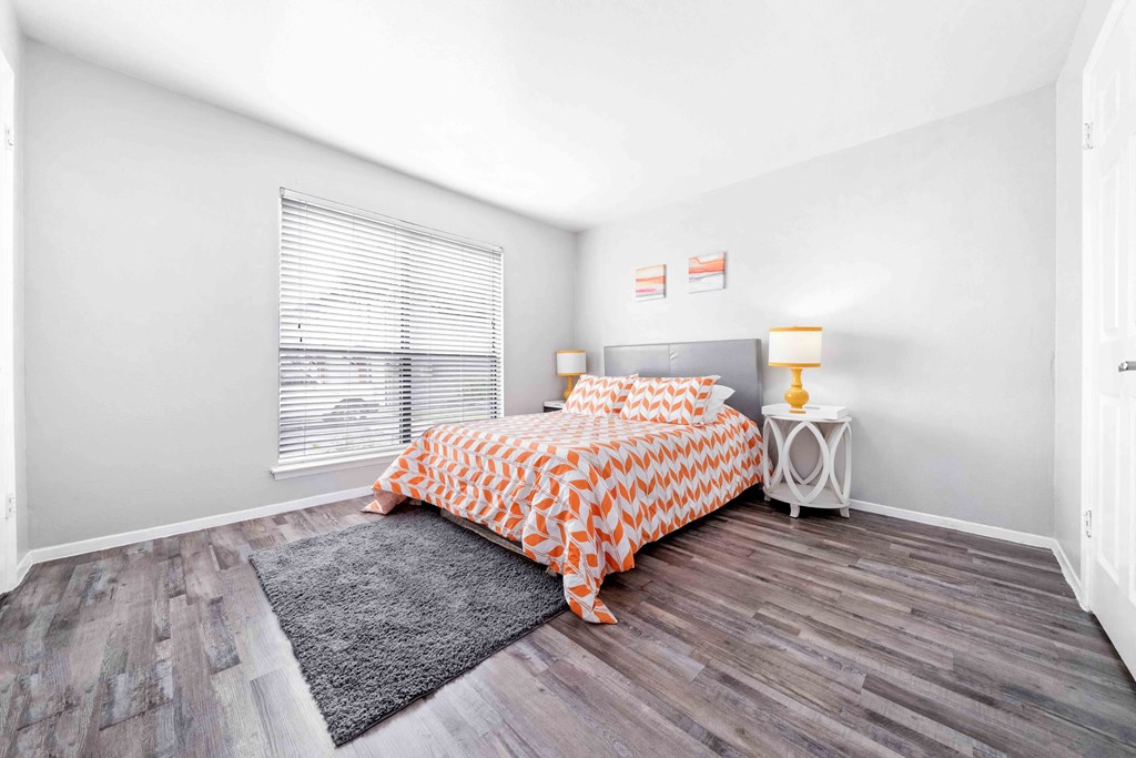Bedroom with a large bed and window at The Stella, Irving, TX