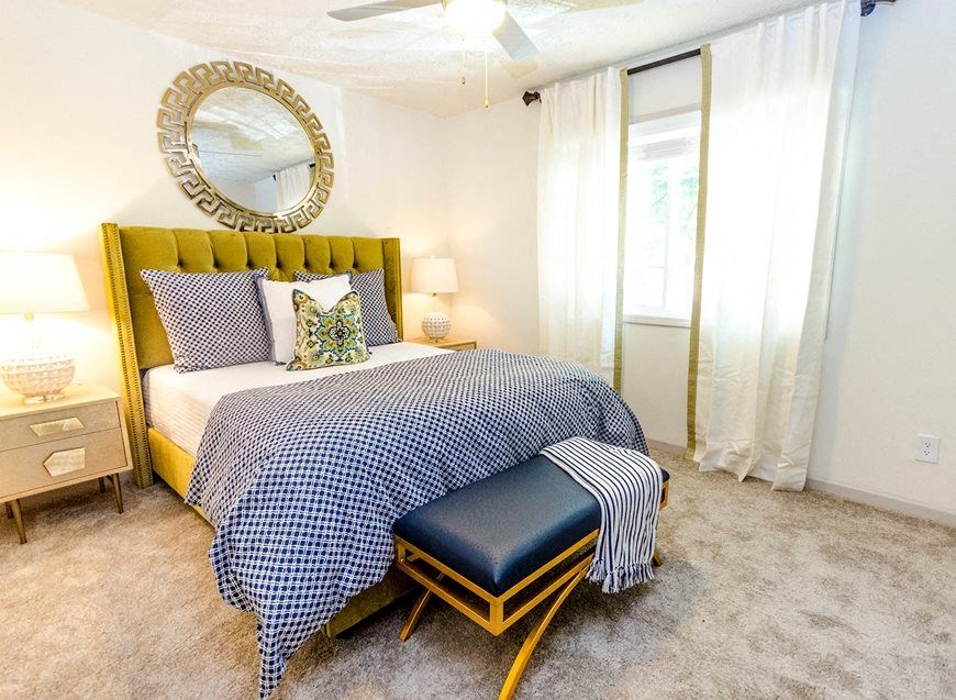 a bedroom with a bed and a mirror