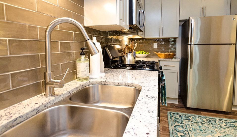 a kitchen with stainless steel appliances and a sink