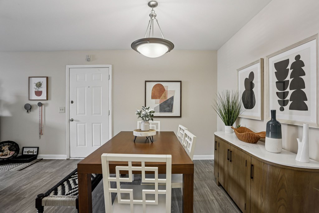 A dining room with a wooden table and chairs.