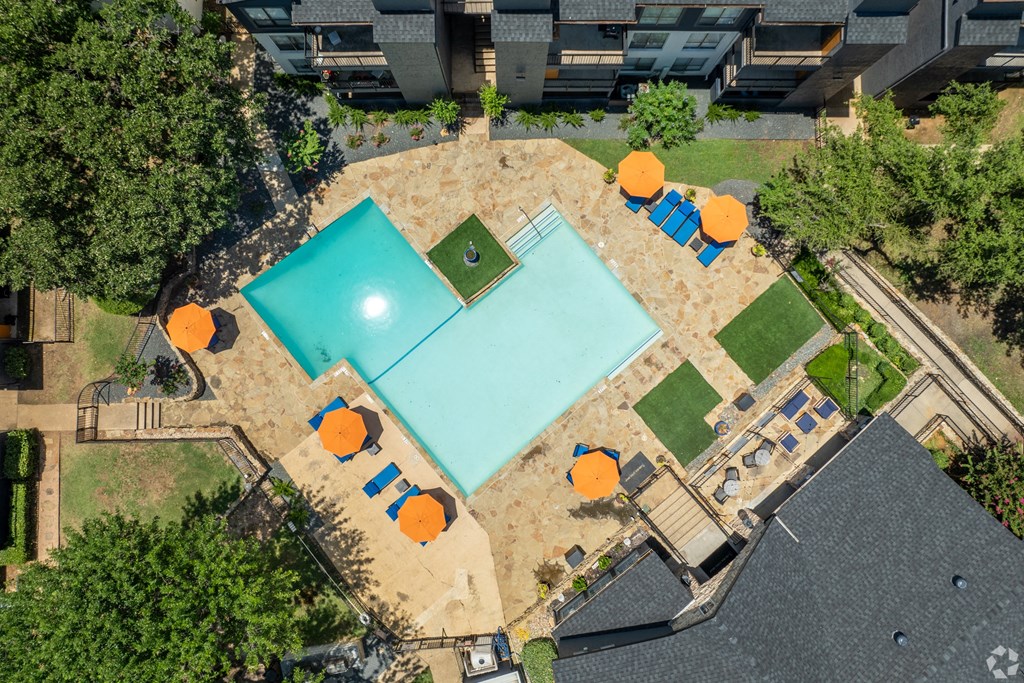 arial view of a pool and tennis court with orange umbrellas and trees at District 2308, Texas, 76011