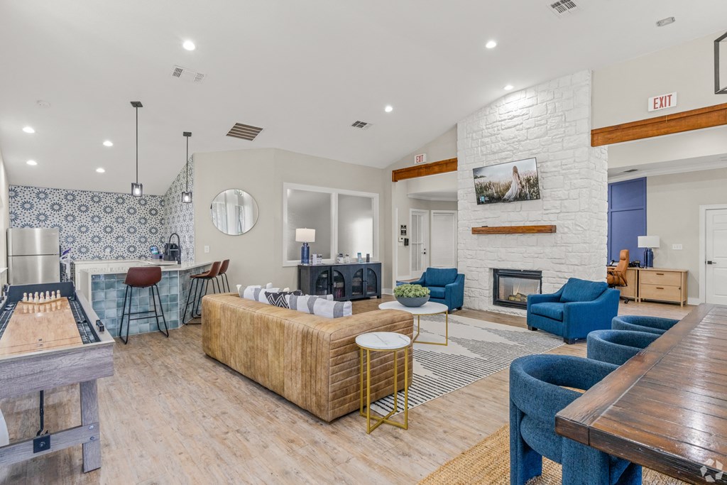 a living room with couches and chairs and a fireplace at District 2308, Texas, 76011