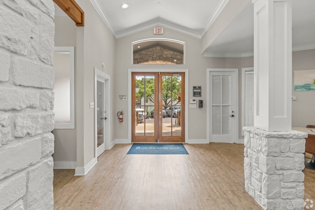 the entrance to the home has a stone wall and wood floors at District 2308, Arlington, TX ?