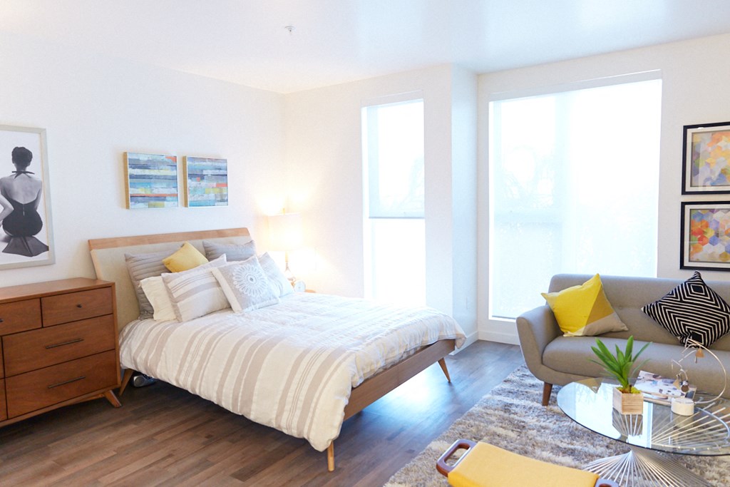 a bedroom with a bed and a chair and a table