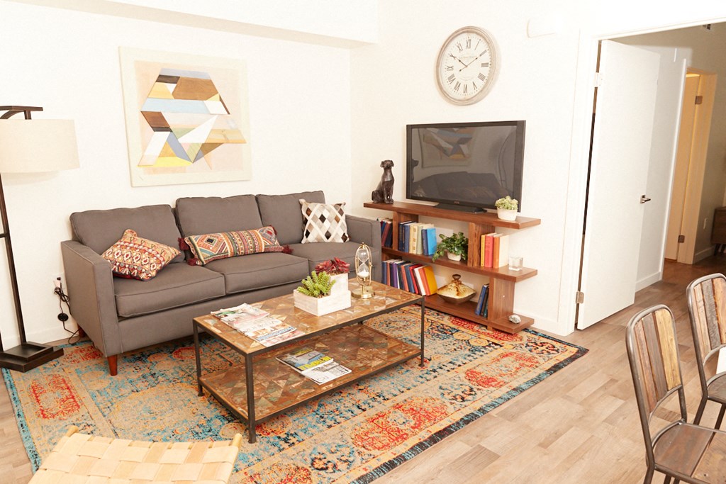 a living room with a couch and a coffee table and a television
