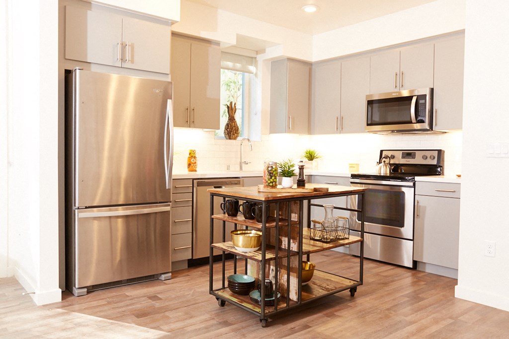 a kitchen with stainless steel appliances and white cabinets