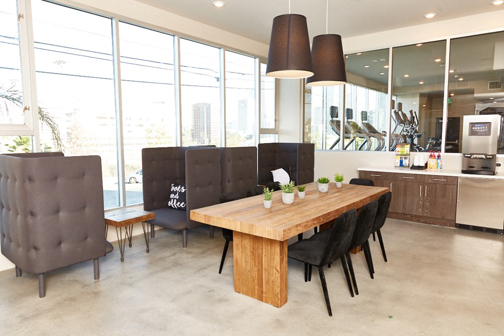 a large dining room with a wooden table and chairs