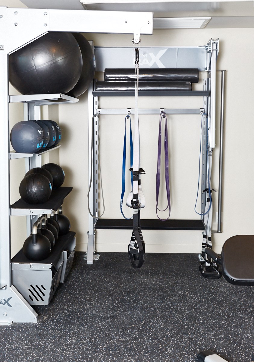 a garage gym with a rack of weights and other equipment