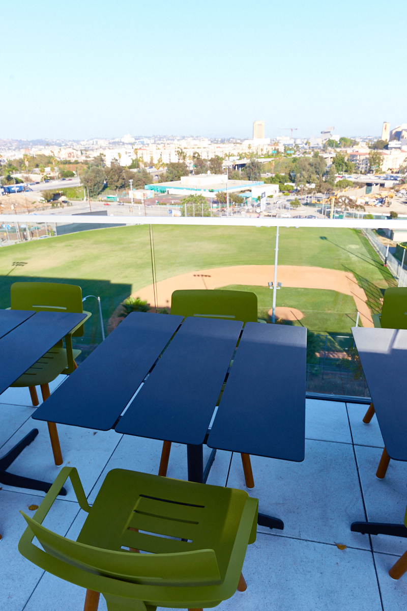 a picnic table with a view of a baseball field