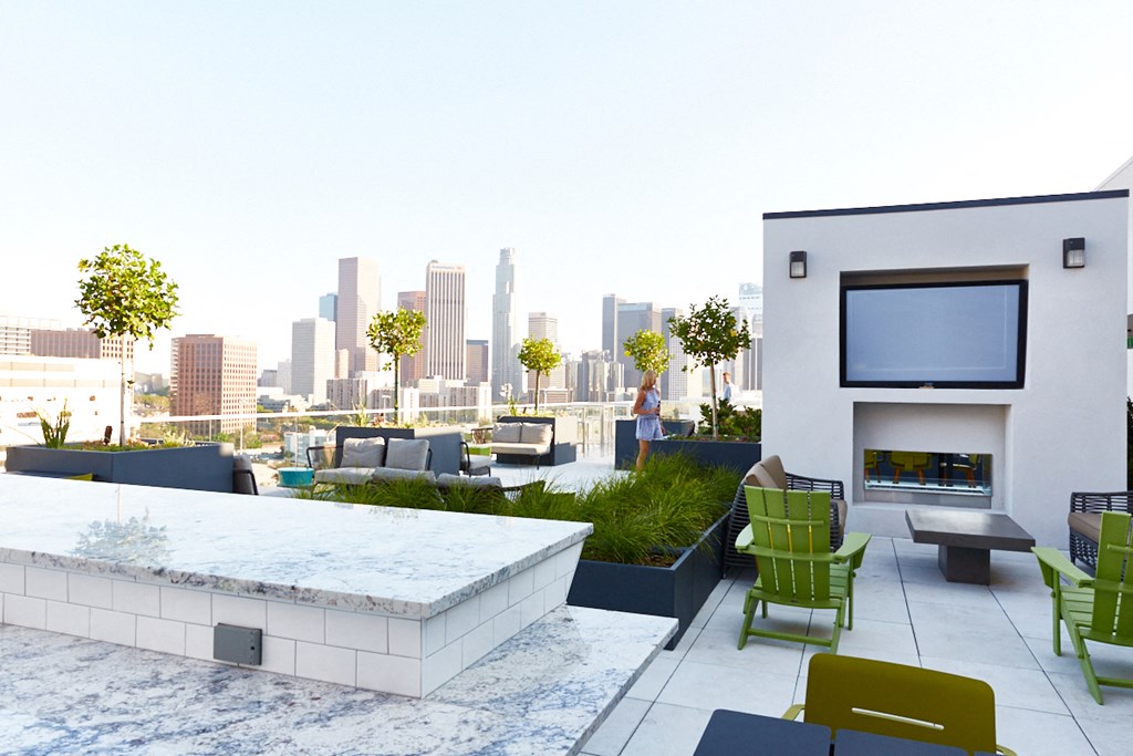 a rendering of a rooftop patio with a city skyline in the background