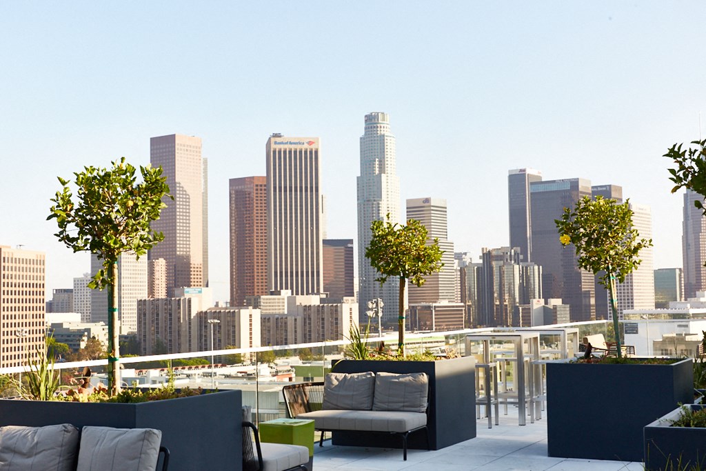 a roof top terrace with a view of a city skyline