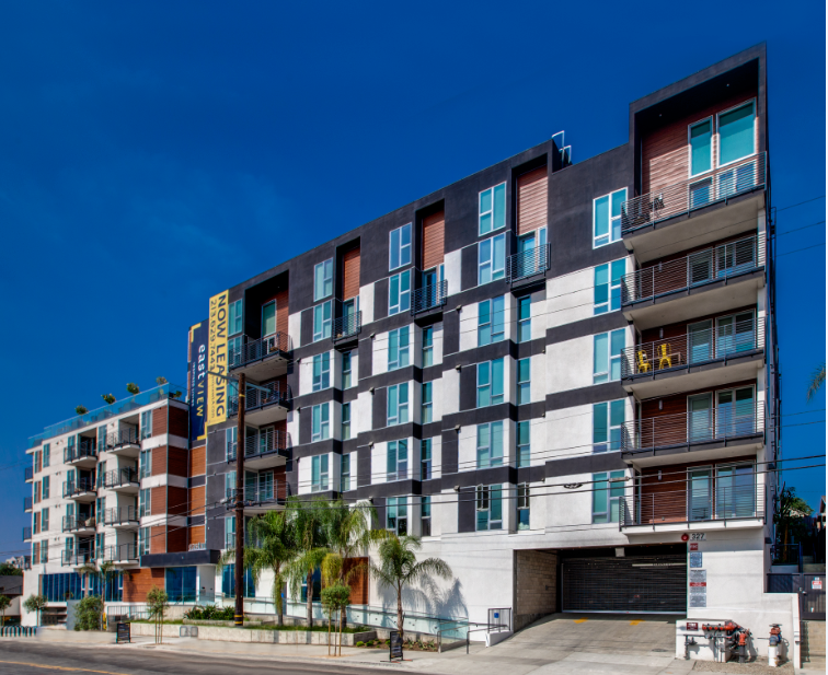 a large apartment building on the side of a street