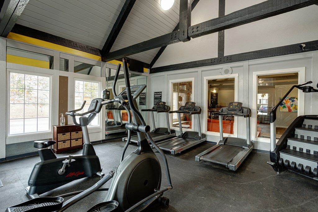 a gym with treadmills and other exercise equipment in a building with windows at The Grove Brentwood, Nashville ?