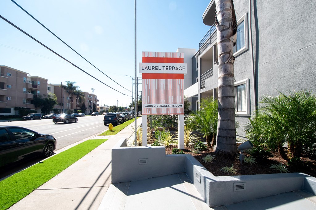 a sign on the side of a building on a city street