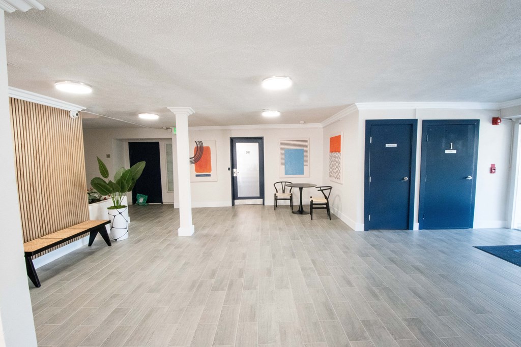 a living room with a wood floor and blue doors