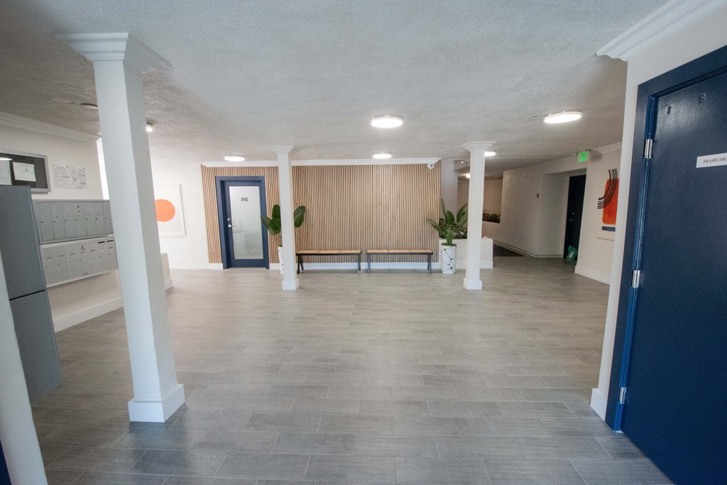 a large room with white pillars and a tile floor