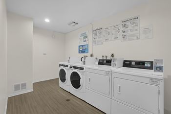 A wall of washing machines in a laundromat.