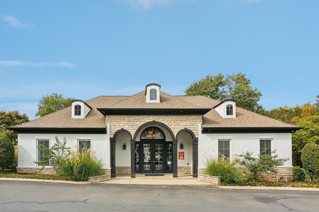 A white building with a black door and windows.