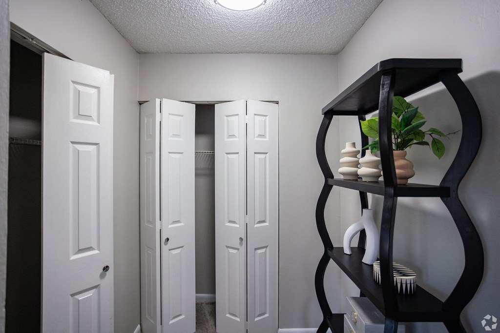 A black shelf with a plant and some decorative items. at The Grove Brentwood, Nashville, TN 37211 