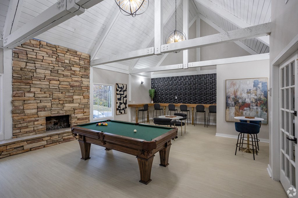 A room with a pool table and a fireplace. at The Grove Brentwood, Nashville, TN 37211 