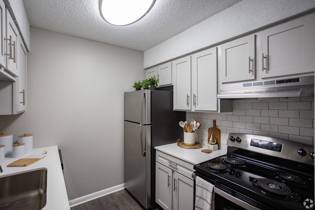 A kitchen A kitchen with a stove, refrigerator, and cabinets. at The Grove Brentwood, Nashville, TN 37211