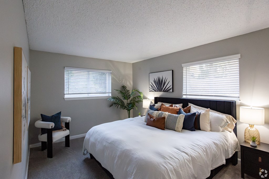 A bedroom with a large bed and a chair. at The Grove Brentwood, Nashville, TN 37211 