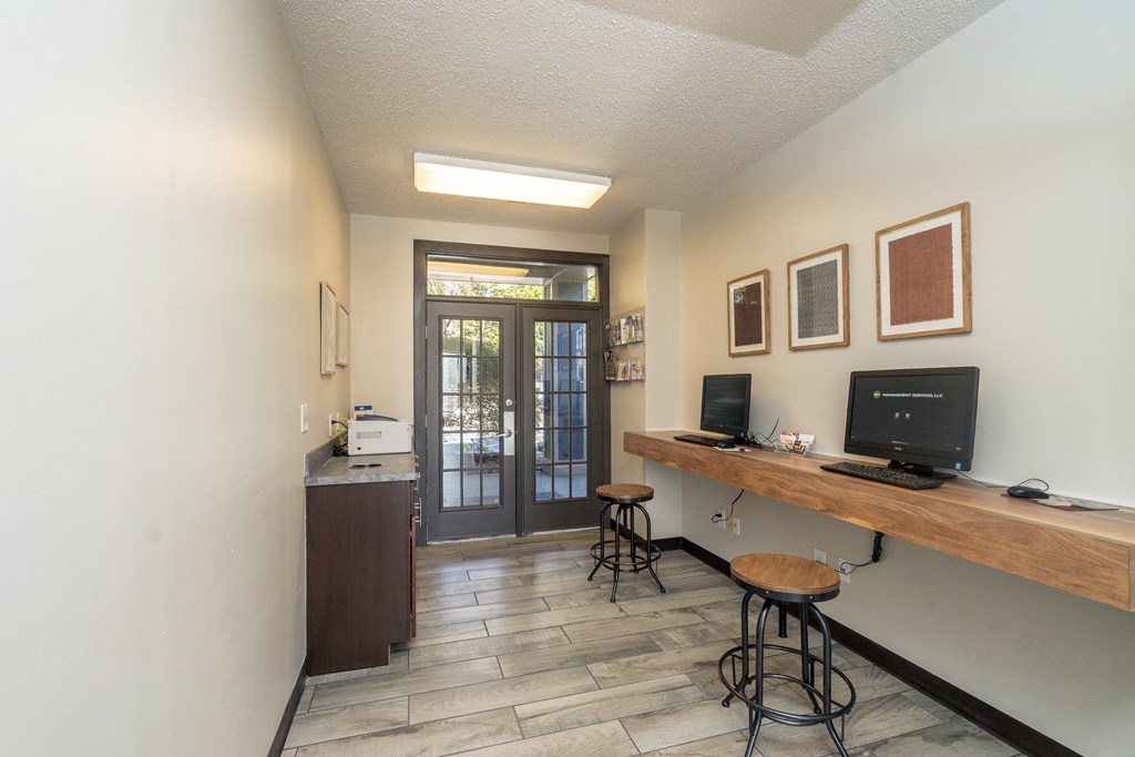 business center with two computers and seating