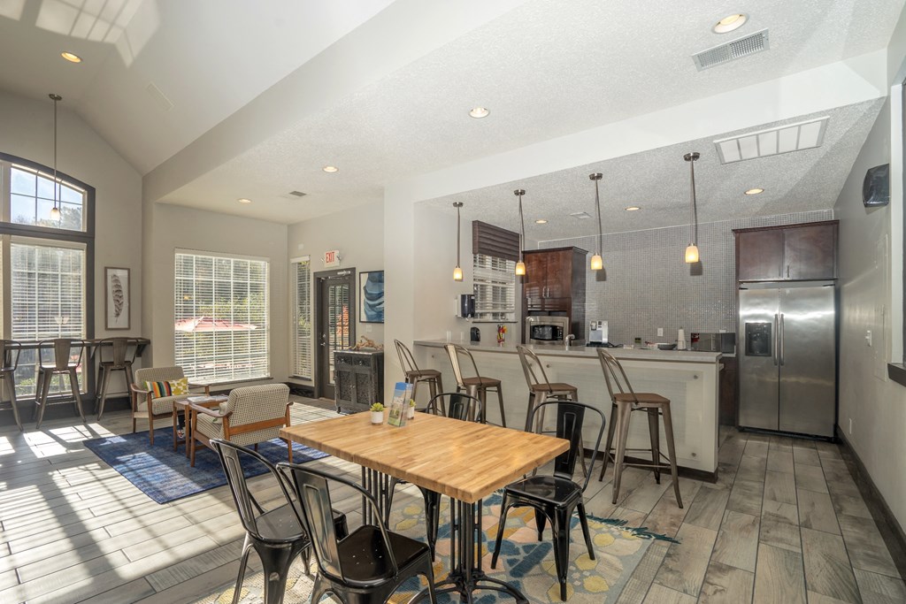 a dining room and kitchen with a table and chairs