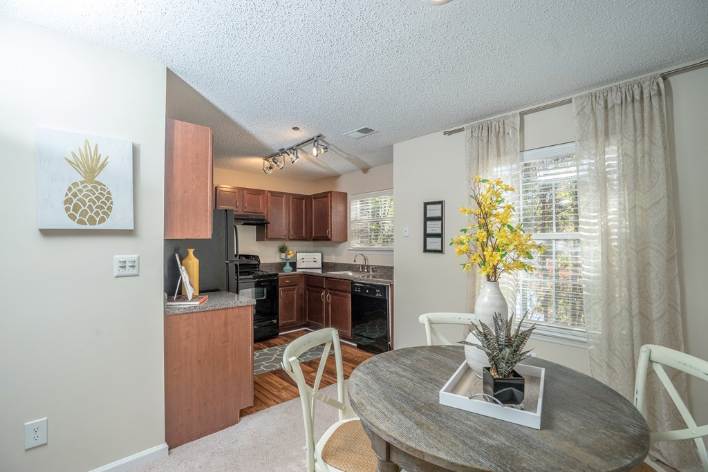 an open kitchen and dining room with a table and chairs