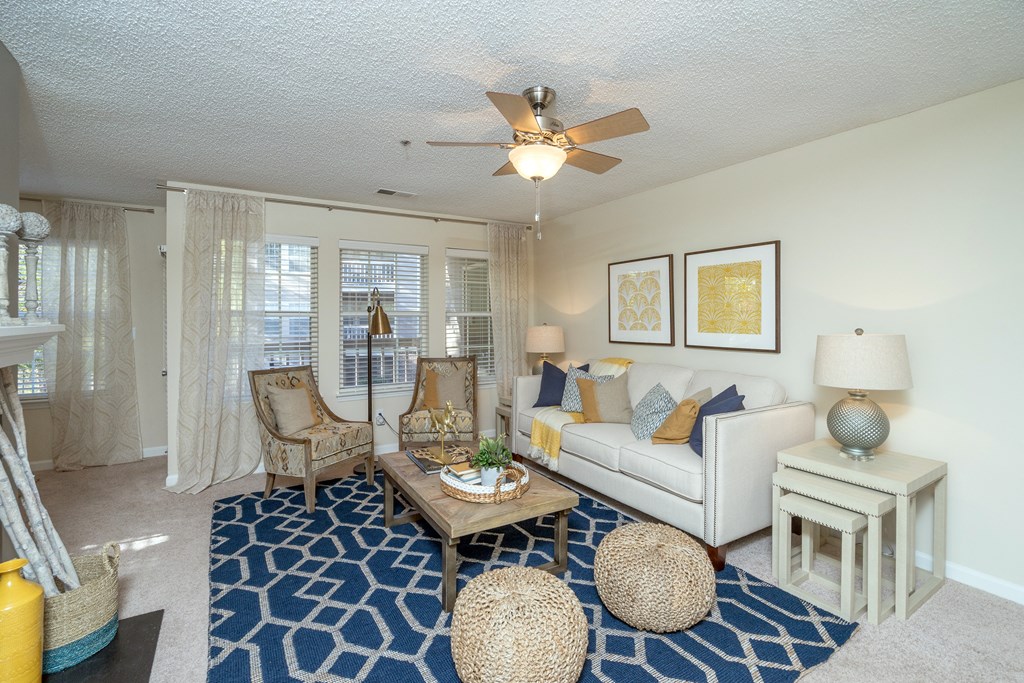 a living room with a ceiling fan and a white couch