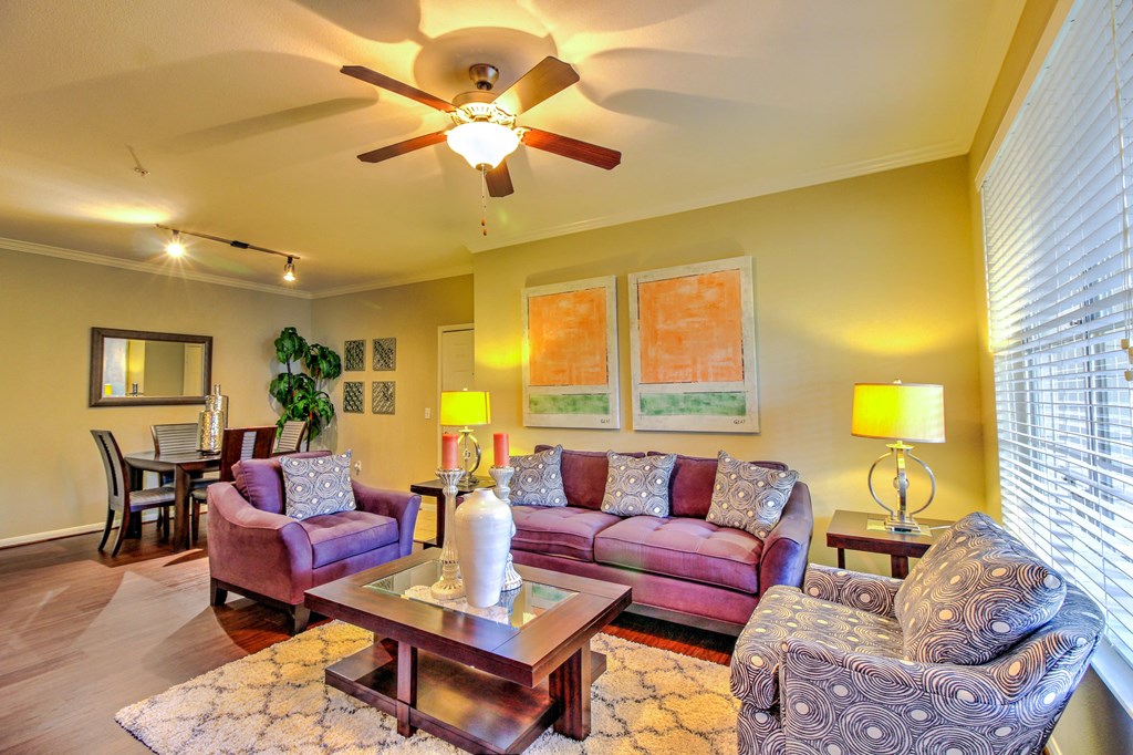 a living room with furniture and a ceiling fan at Stone Creek at Old Farm Apartments, Texas 77063