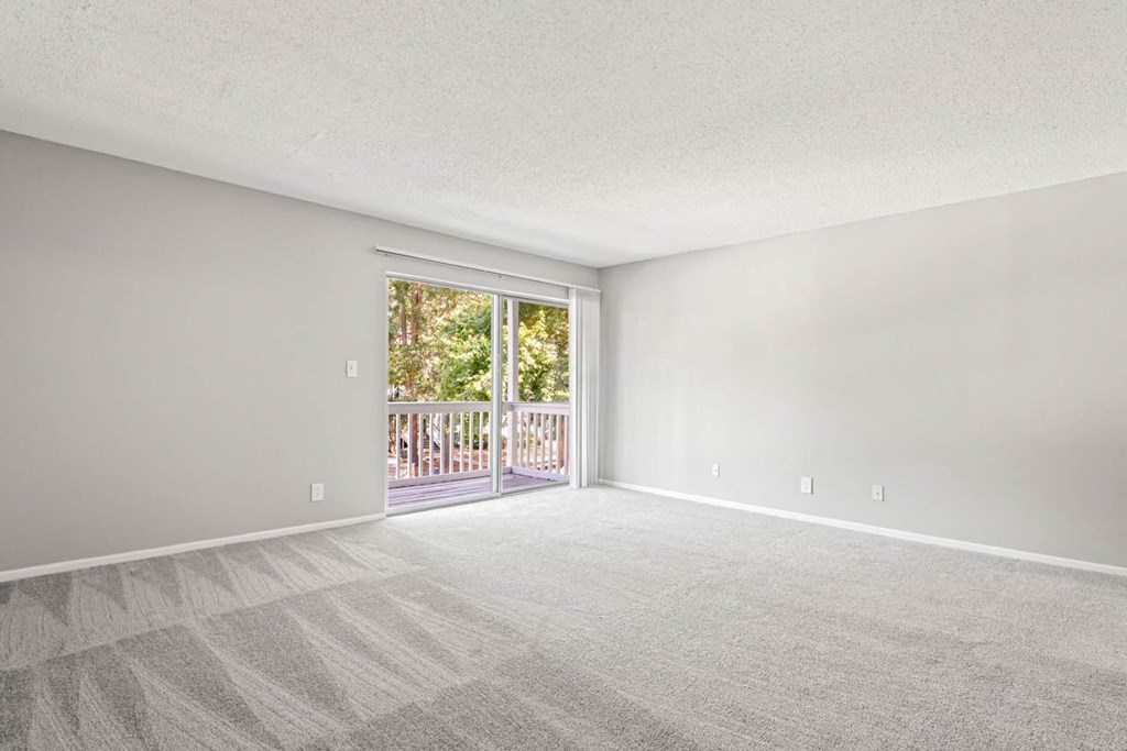 a bedroom with a sliding glass door leading to a balcony